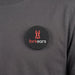 Multi-Functional Magnetic Badge - A round black magnetic badge featuring a logo and placed on a grey shirt.