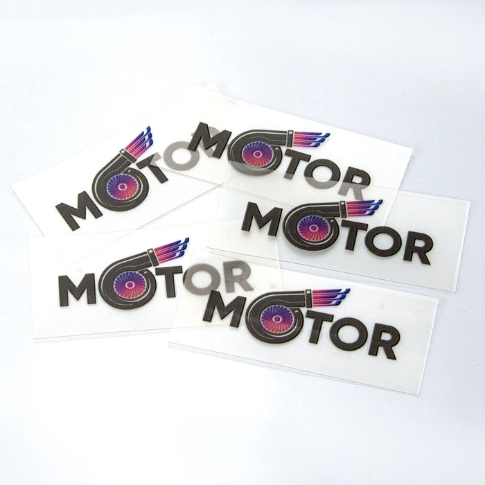 Prism Print - 55 x 24mm Sticker - A selection of clear stickers featuring the word "MOTOR" and a graphic of a stylised motor icon.
