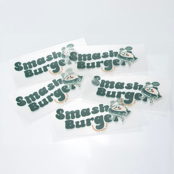 Prism Print - 100 x 50mm Sticker - A collection of green and white stickers featuring a playful logo and branding for "Smash Burger."