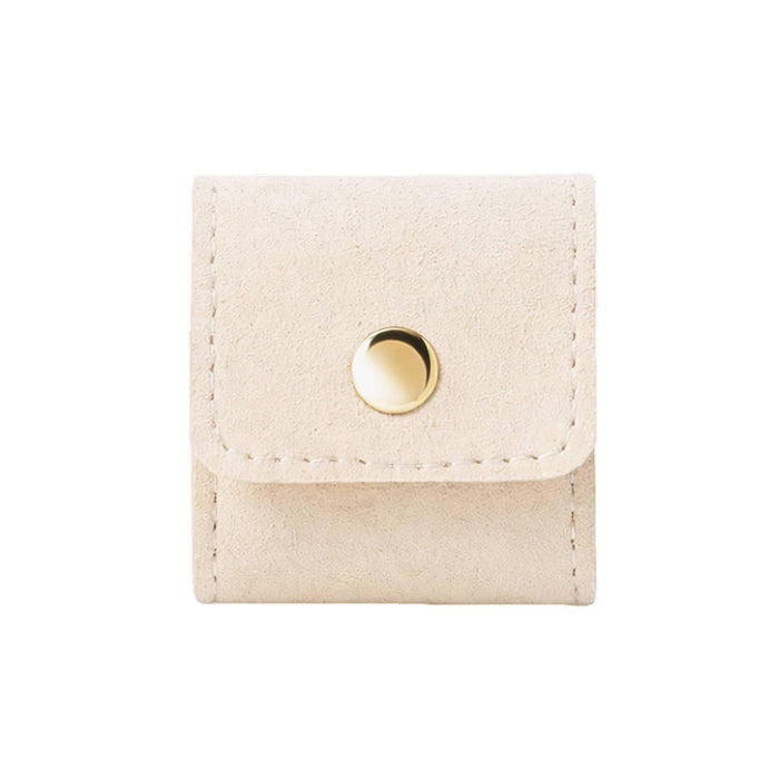 Mini Synthetic Leather Jewellery Bag - A mini synthetic leather jewellery bag in a cream colour, featuring a gold snap button closure and stitched edges.