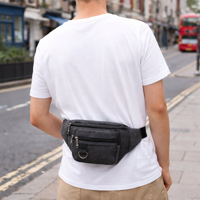 Canvas Waist Bag - A grey canvas waist bag worn at the back of a person, standing on a street.
