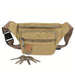 Canvas Waist Bag - A tan canvas waist bag with multiple zippered pockets and a key ring attached, featuring a brown strap.