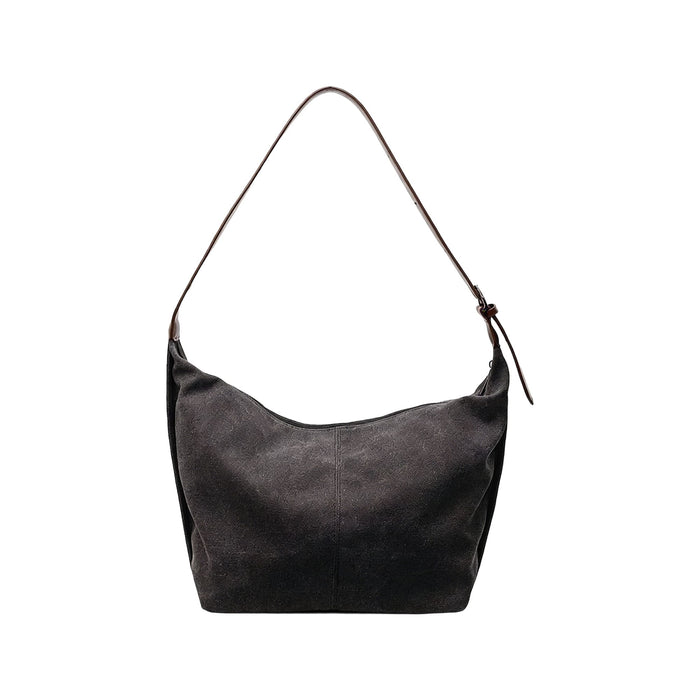 Dumpling Canvas Tote Bag - A dark grey canvas tote bag with a single brown leather strap and a minimalist design. Features a logo.