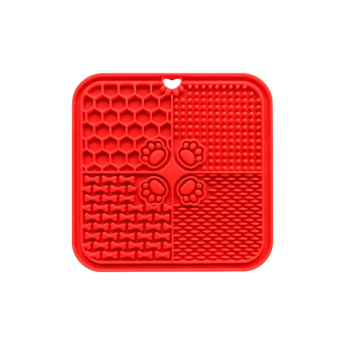 4-Section Dog Enrichment Lick Mat - A red, four-section dog enrichment lick mat with various textured patterns, including paw prints and bone shapes.