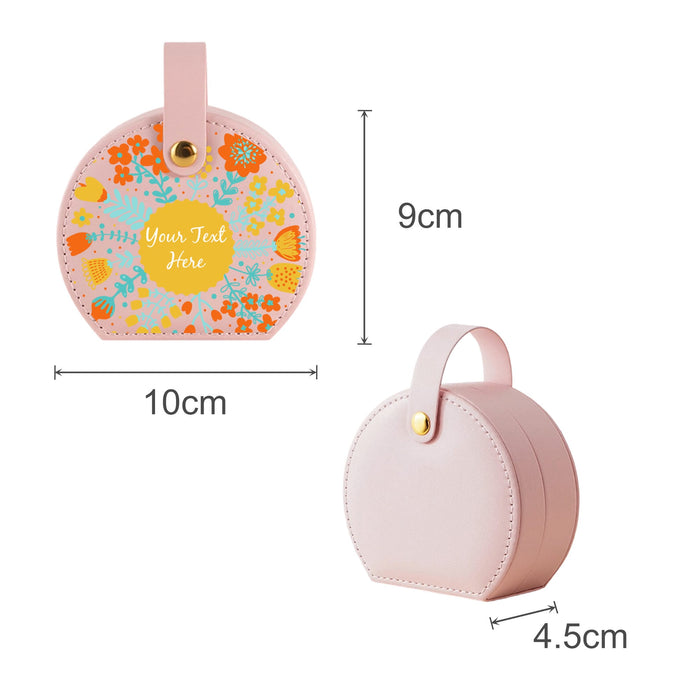 Small Portable PU Leather Jewellery Box - A small portable pink PU leather jewellery box with a floral design and a handle, measuring 9cm by 10cm.