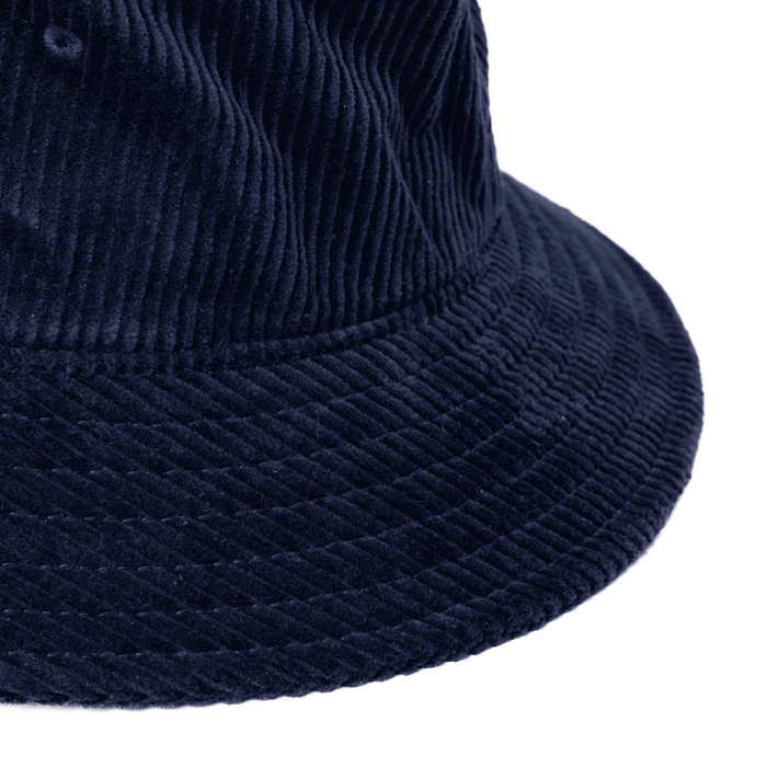 Atlanta Cord Bucket Hat - A navy cord bucket hat featuring a textured fabric and a wide brim. The hat includes a branding logo.