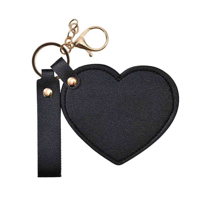 Heart-Shaped Compact Mirror with Keychain - A heart-shaped black compact mirror with a keychain attachment and a gold clasp.