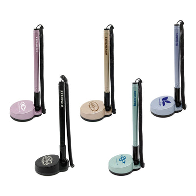 Counter Fixed Signature Pen D - A set of five fixed signature pens on stands, featuring pastel colours like pink, beige, and blue, with various branding.