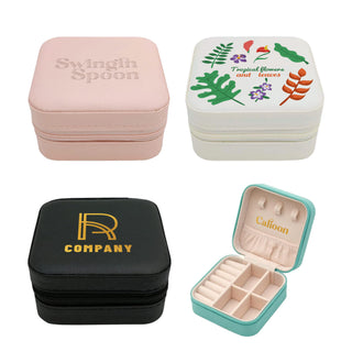 PU Leather Jewellery Box - A collection of PU leather jewellery boxes in pink, white with a floral design, black with gold branding, and teal inside.