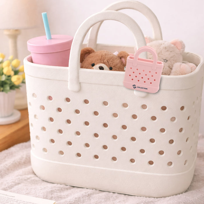 Mini EVA Holes Bag Clip - A basket with a white design featuring holes, holding a pink drink bottle, a teddy bear, and a soft toy.