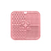 4-Section Dog Enrichment Lick Mat - A pink, four-section dog enrichment lick mat featuring various textured patterns, including paw prints and bones, with a central hole.