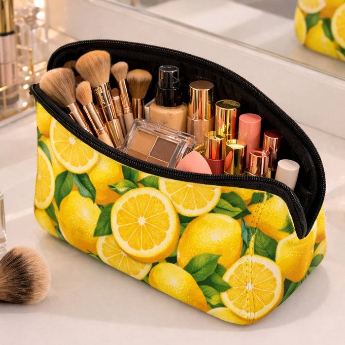 Neoprene Cosmetic Bag - A yellow neoprene cosmetic bag filled with makeup brushes and various cosmetic products, featuring a lemon design.