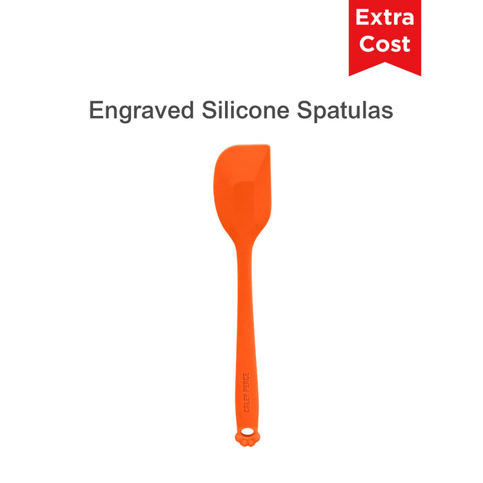 4-Section Dog Enrichment Lick Mat - An orange silicone spatula with a flat head and a long handle, featuring an engraved design and a logo.
