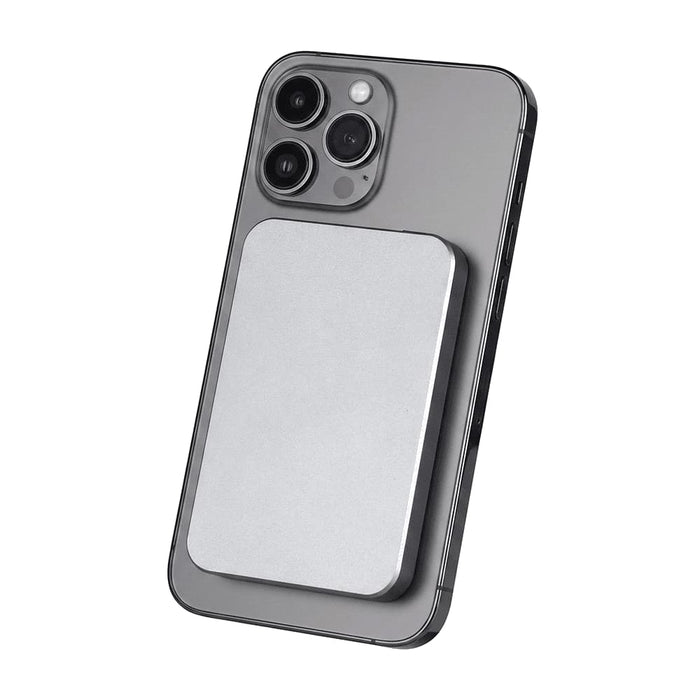 Quantum Pro Power Bank w/ Semi-Solid State Battery 5000mAh - A silver power bank attaches magnetically to the back of a grey smartphone, featuring a sleek design.
