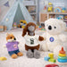 Plush Doll Basic T-Shirt - A plush doll wearing a white T-shirt, alongside a koala and a fox in colourful outfits, with toys in the background.