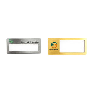 Reusable Metal Name Badge - Two reusable metal name badges in silver and gold finishes, featuring a clear window for name display and logos.