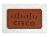 Calico Travel Set - A brown leather patch featuring a logo, with tan stitching on a light fabric background.