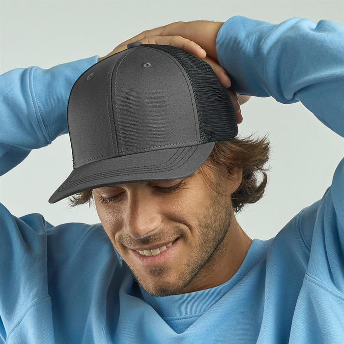 Sonic-S Organic/Recycled Trucker - A grey trucker cap with a mesh back, worn by a smiling man in a light blue sweatshirt.