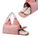 Duffle Bag With Yoga Mat Strap - A pink duffle bag featuring a compartment for shoes, designed with a stylish handle and a zippered opening.