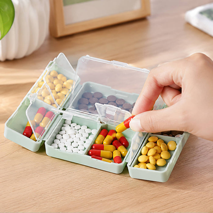 Folding 7 Compartment Pills Box - A folding pills box in green with seven compartments, holding various types and colours of pills.