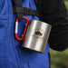170ML/280ML Stainless Steel Insulated Travel Mug with Carabiner Handle - A stainless steel insulated travel mug, silver in colour, attached with a red carabiner handle.