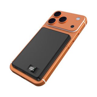 Bryan Ultra Thin 15W MagSafe Power Bank - 5000 mAh (Stock) - An orange smartphone with a black ultra-thin power bank attached, featuring three camera lenses on the back.