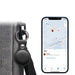 MiTag Duo Global Tracking Tag with PU Case (stock) - A black tracking tag attached to a bag, with a smartphone displaying a map and item location.