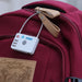 MiLock Duo Tag Luggage Lock - A white luggage lock with a combination dial is attached to a maroon backpack. The lock features a branded logo.