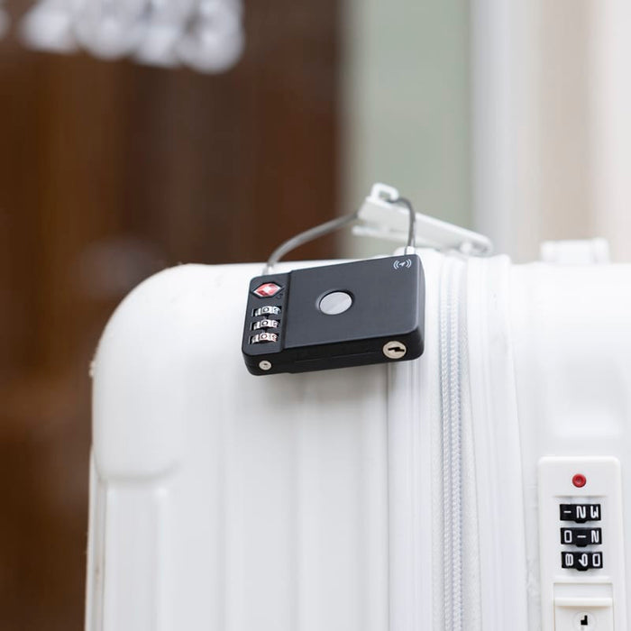 MiLock Duo Tag Luggage Lock - A black luggage lock is attached to a white suitcase, featuring a circular button and combination dials.