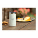 Arctic Zone Titan Thermal HP Slim Cooler 350ml - A drink bottle in white with a silver lid, sitting on a wooden table beside snacks and treats.