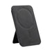 Wally Stand - A black phone stand with a circular magnetised area and stitching details, featuring a logo on the surface.