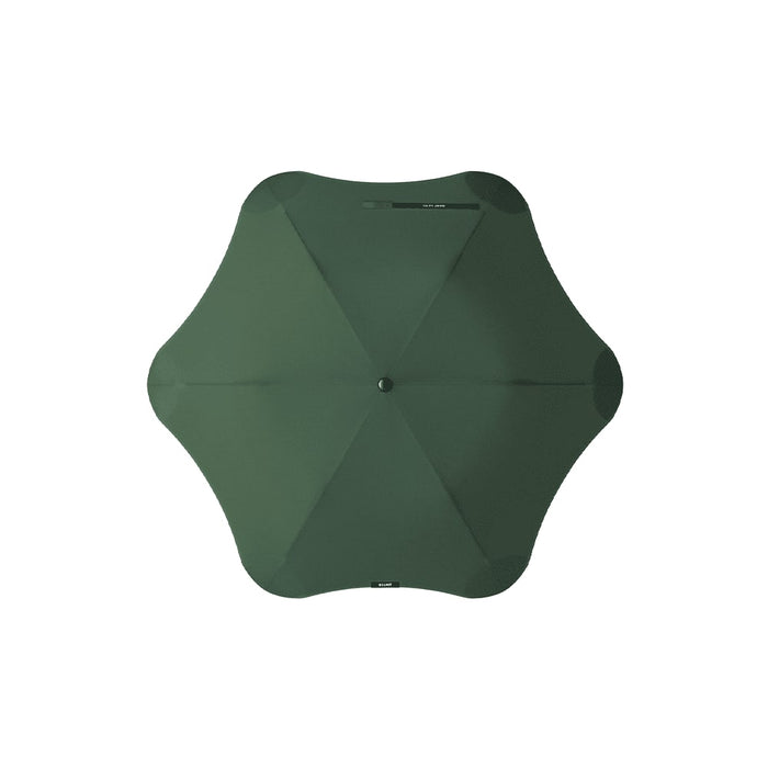 The Blunt Umbrella All Weather Set - A green BLUNT Metro umbrella with a unique octagonal shape and a central button for opening and closing.
