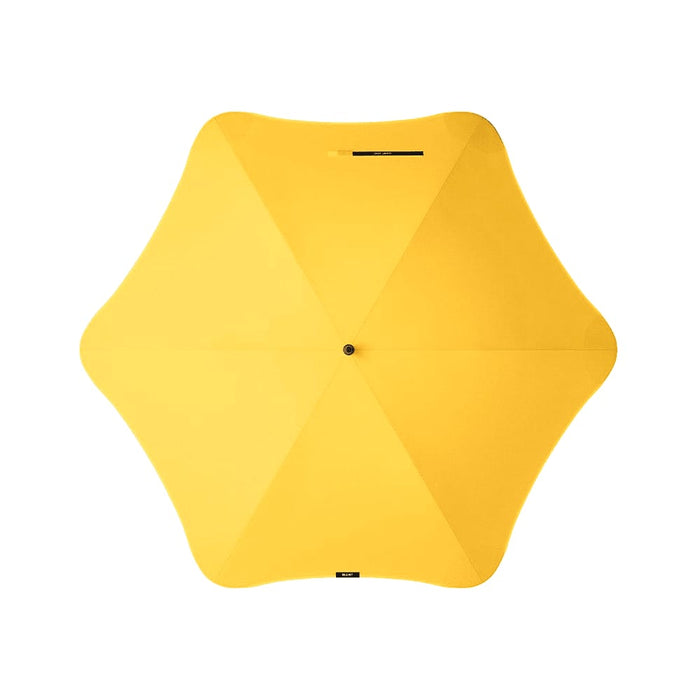 BLUNT Exec Umbrella - A yellow umbrella with a unique star shape, featuring a central button and a logo.