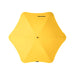 BLUNT Exec Umbrella - A yellow umbrella with a unique star shape, featuring a central button and a logo.