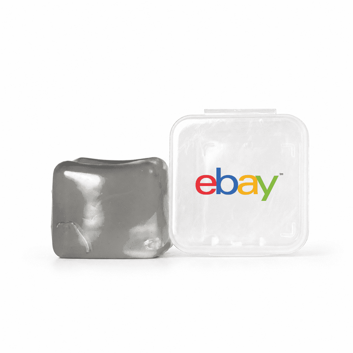 Jelly Cube Sensory Toy - A grey jelly cube sensory toy next to a transparent container featuring a logo.