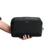 Bellroy Lite Packing Cube 6L - A black packing cube held in a hand, featuring a mesh panel and branded logo.