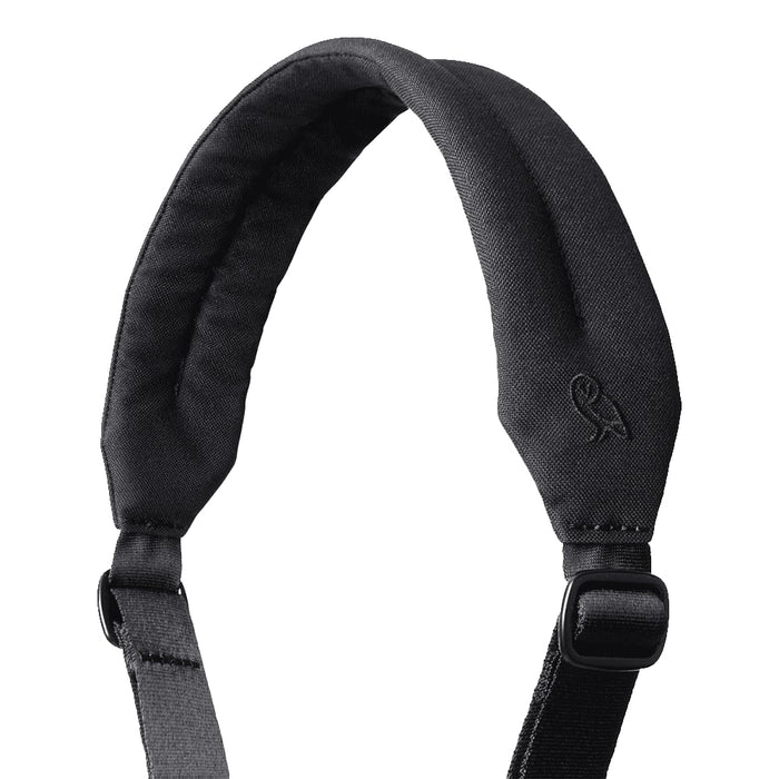 Bellroy Classic Duffel 45L - A padded black shoulder strap with an adjustable buckle and a logo at the top.
