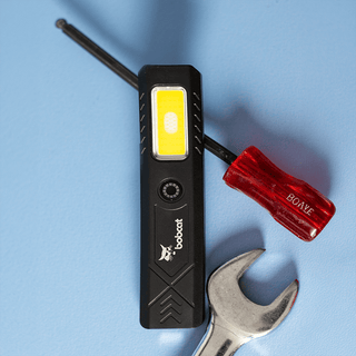 Rechargeable Work Light - A rechargeable work light in black with a yellow light panel, alongside a red screwdriver and a silver wrench.