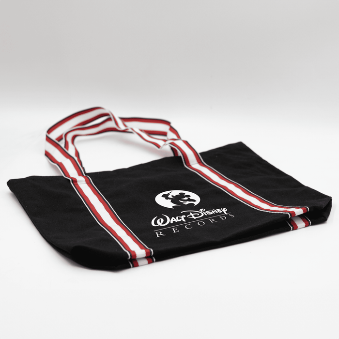 Century Canvas Tote Bag - A black canvas tote bag with red and white striped handles and a logo.