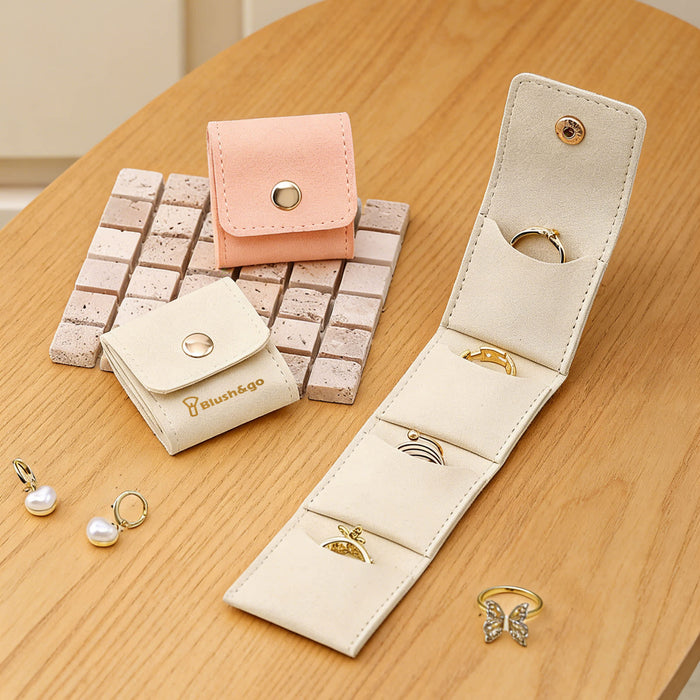 Mini Synthetic Leather Jewellery Bag - A mini synthetic leather jewellery bag in beige and peach, displaying compartments for rings and earrings.