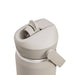 CamelBak - Thrive Flip Straw VSS 0.6L - A drink bottle in a light beige colour featuring a flip straw and a side lever for easy opening, with branding visible.
