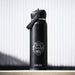 CamelBak - Thrive Flip Straw VSS 1.0L - A drink bottle in matte black with a flip straw lid and a logo featuring a vanlife theme.