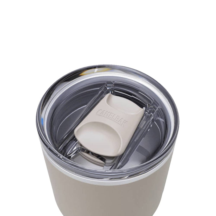 CamelBak - Thrive Tumbler VSS 0.9L - A drink bottle featuring a lid with a spout, in a light beige colour, with a clear rim and a logo.