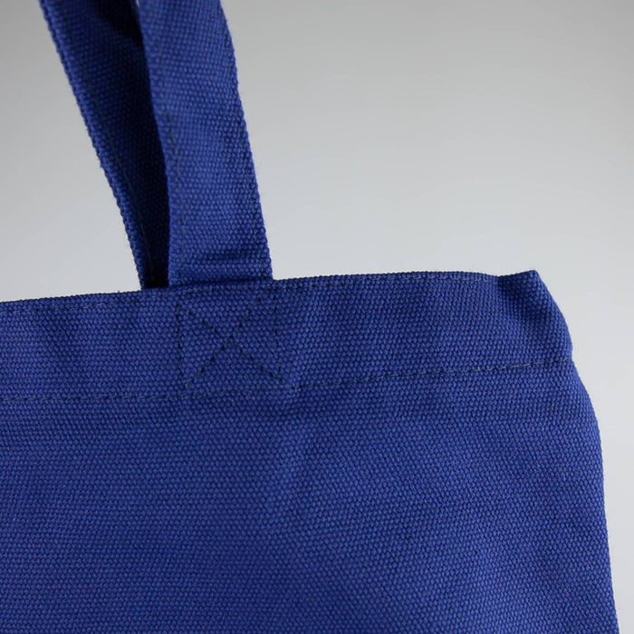 450gsm Hawaiian Canvas Tote Bag - A blue 450gsm Hawaiian canvas tote bag with sturdy handles and a textured finish, featuring a logo.