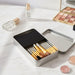 12-Piece Brush with Metal Box Set - A metal box set containing 12 makeup brushes with silver handles and gold detailing.