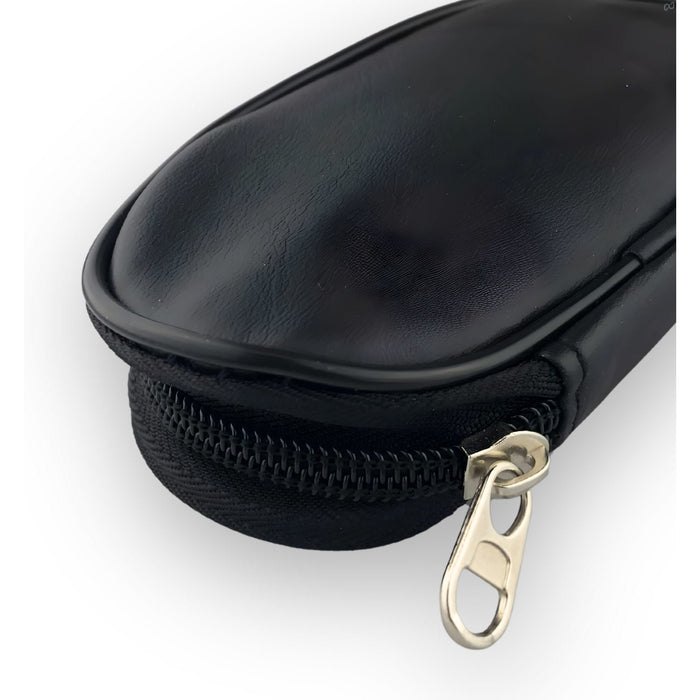 9 Brushes in a Case - A black case featuring a zip closure, designed to hold multiple brushes. It has a sleek, smooth surface.