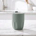 Carry Cup Olla Vacuum Coffee Cup w/ Ceramic Liner - 300ml - A drink bottle in a soft green hue with a clear lid, featuring a textured body and an internal ceramic liner.