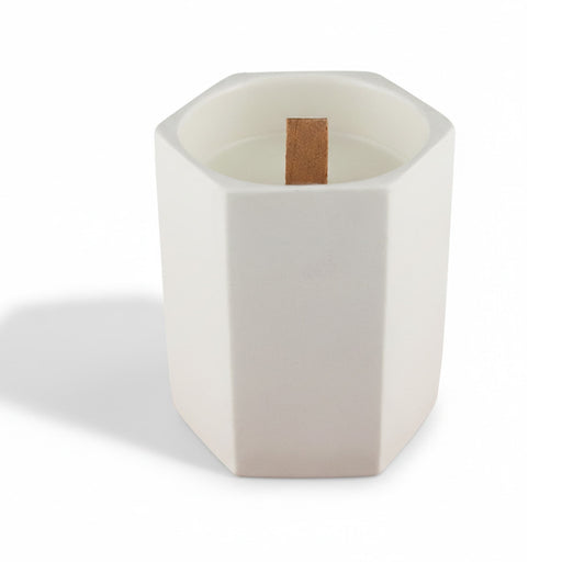 Noosa Hexagon Ceramic Candle - A white hexagonal ceramic candle with a wooden wick placed inside. It has a minimalist design.
