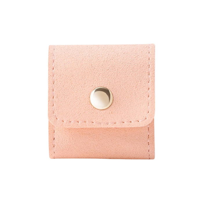 Mini Synthetic Leather Jewellery Bag - A pink mini synthetic leather jewellery bag with a snap closure and stitching detail. It features a small logo.
