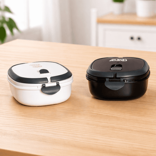 The Lunch Box 800ml - A lunch box set featuring a black and a white container, both with secure lids and separate compartments.